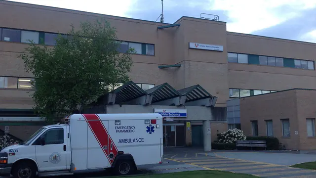 An ambulance outside the main entrance of Langley Memorial Hospital in the Township of Langley, British Columbia