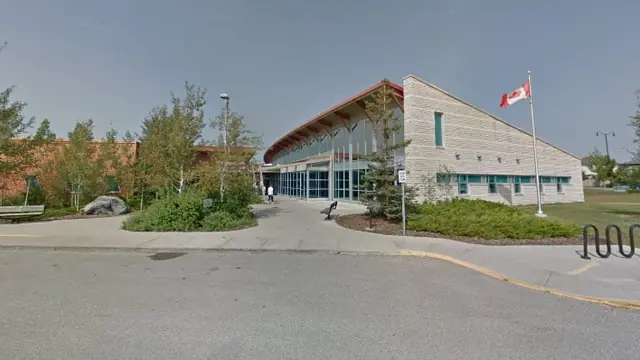 The stone and glass front of Okotoks Health and Wellness Centre in Okotoks, Alberta